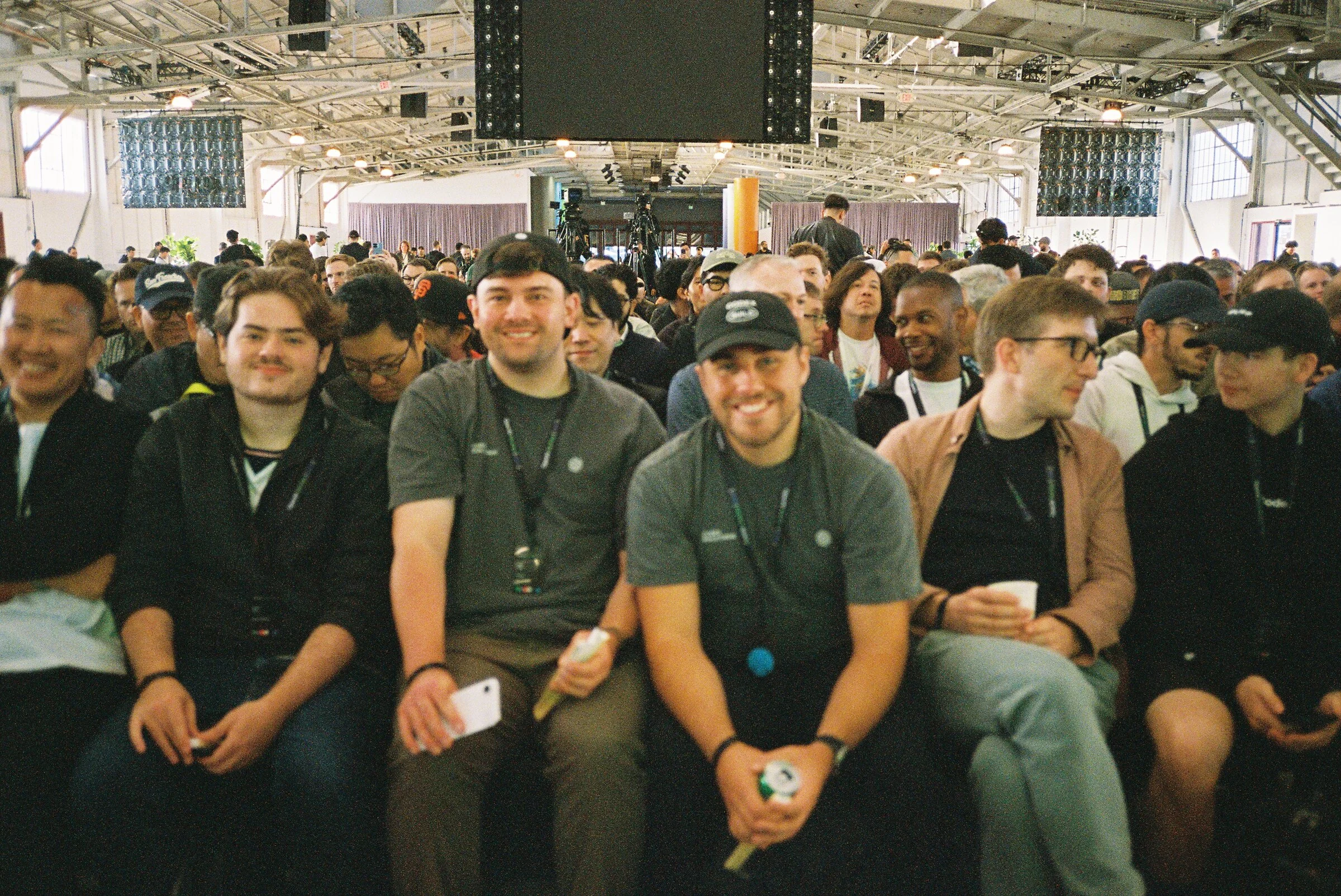 A row of seated attendees smiling at the camera