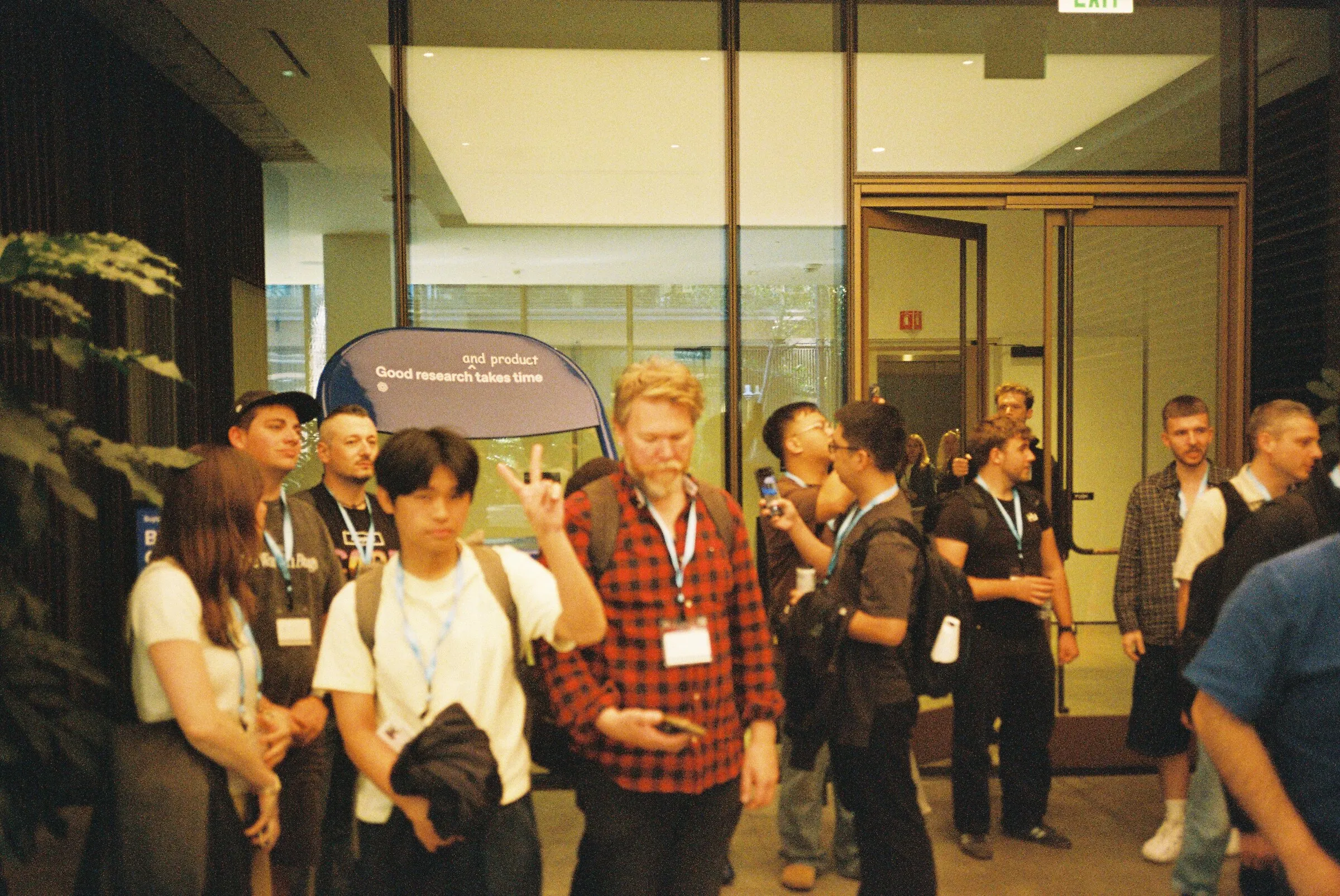 A group gathered in an office lobby, some mid-pose