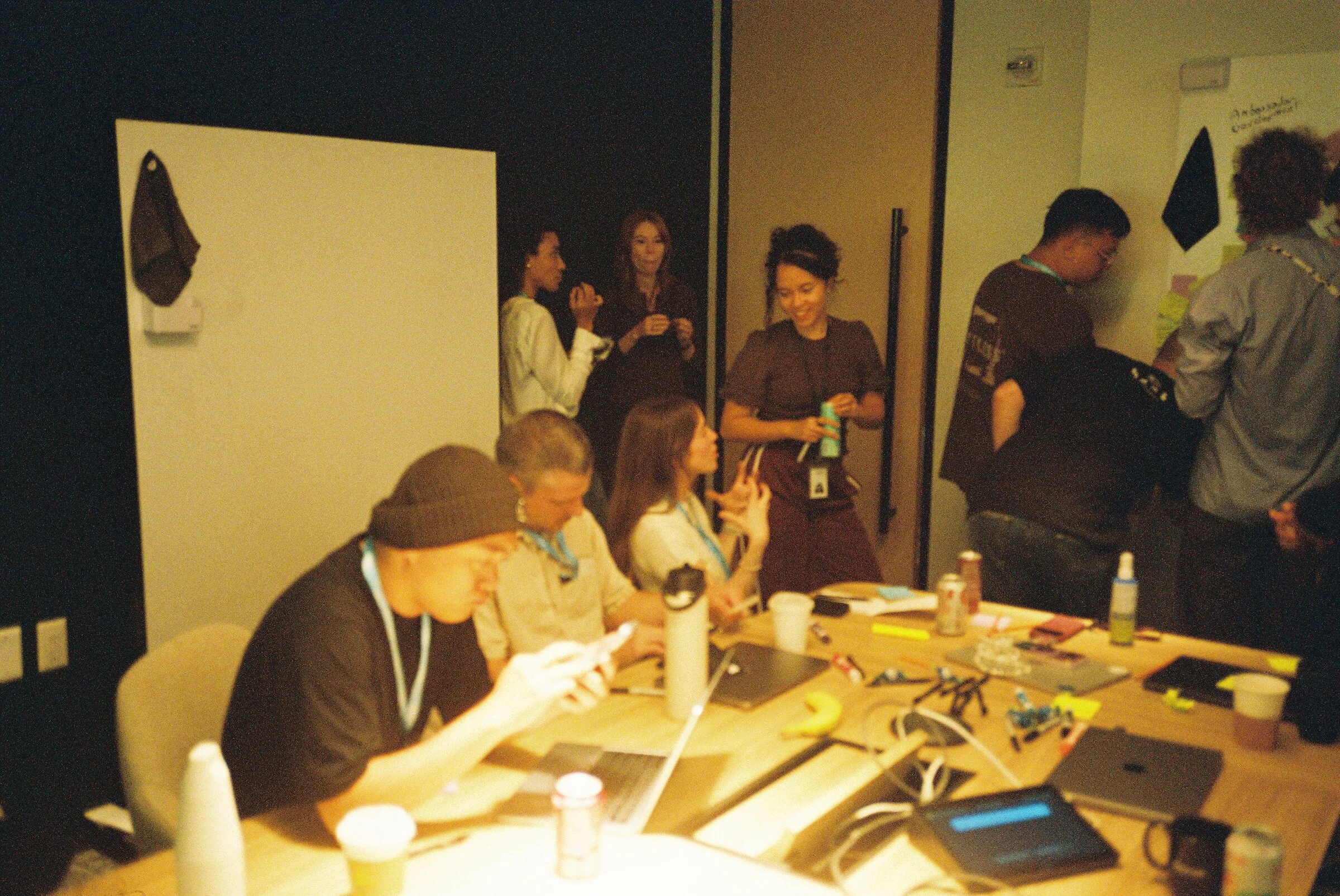 People adding sticky notes to a wall