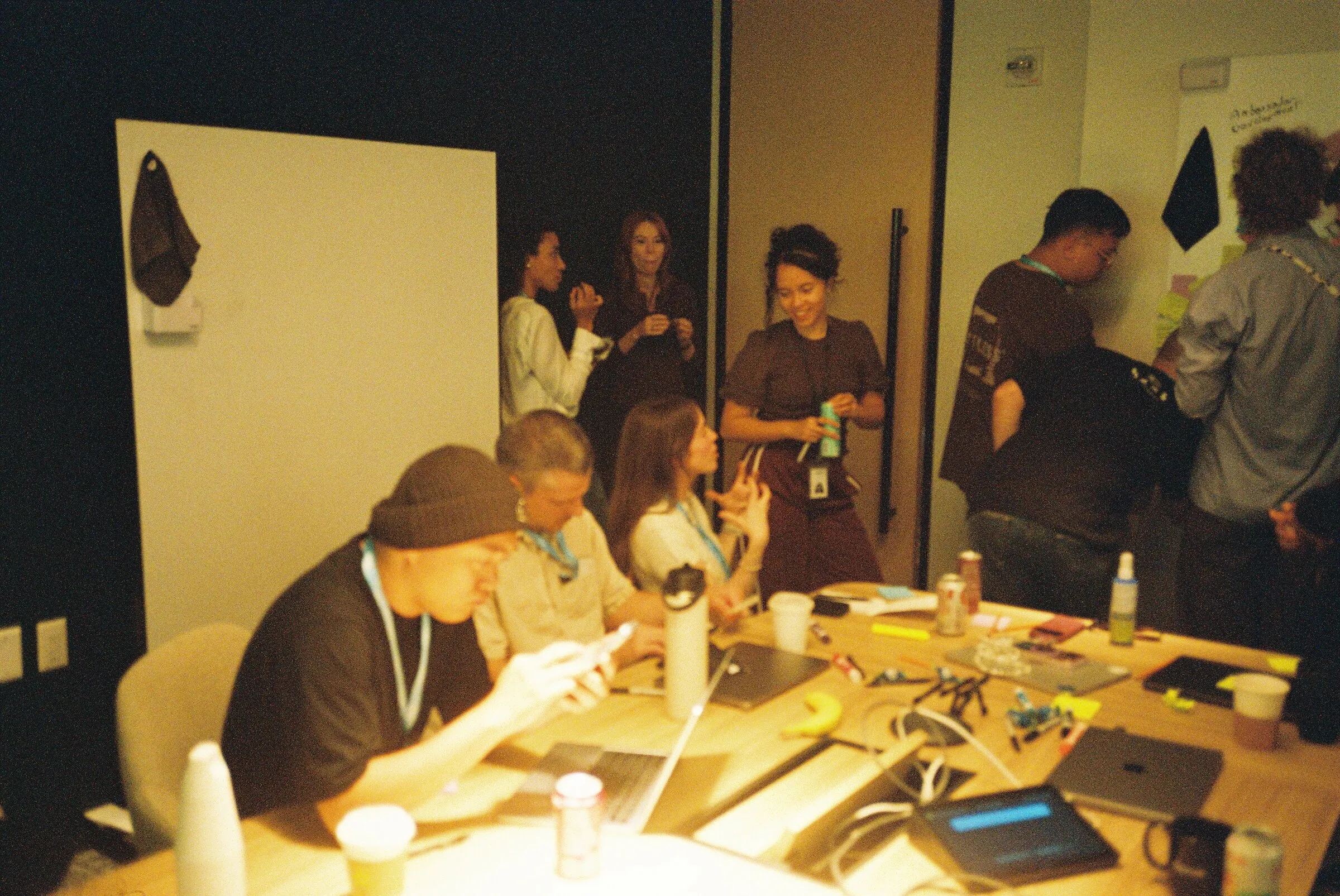 People adding sticky notes to a wall