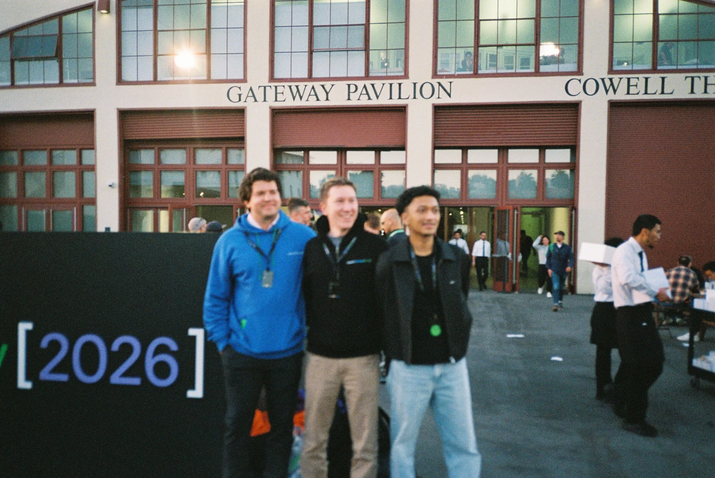 Four people posing outside the Gateway Pavilion and Cowell Theater